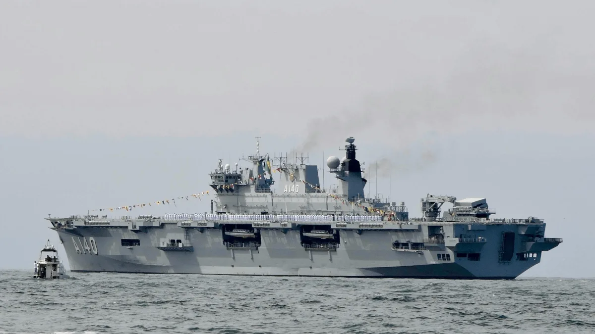 a large naval aircraft carrier sailing on the ocean
