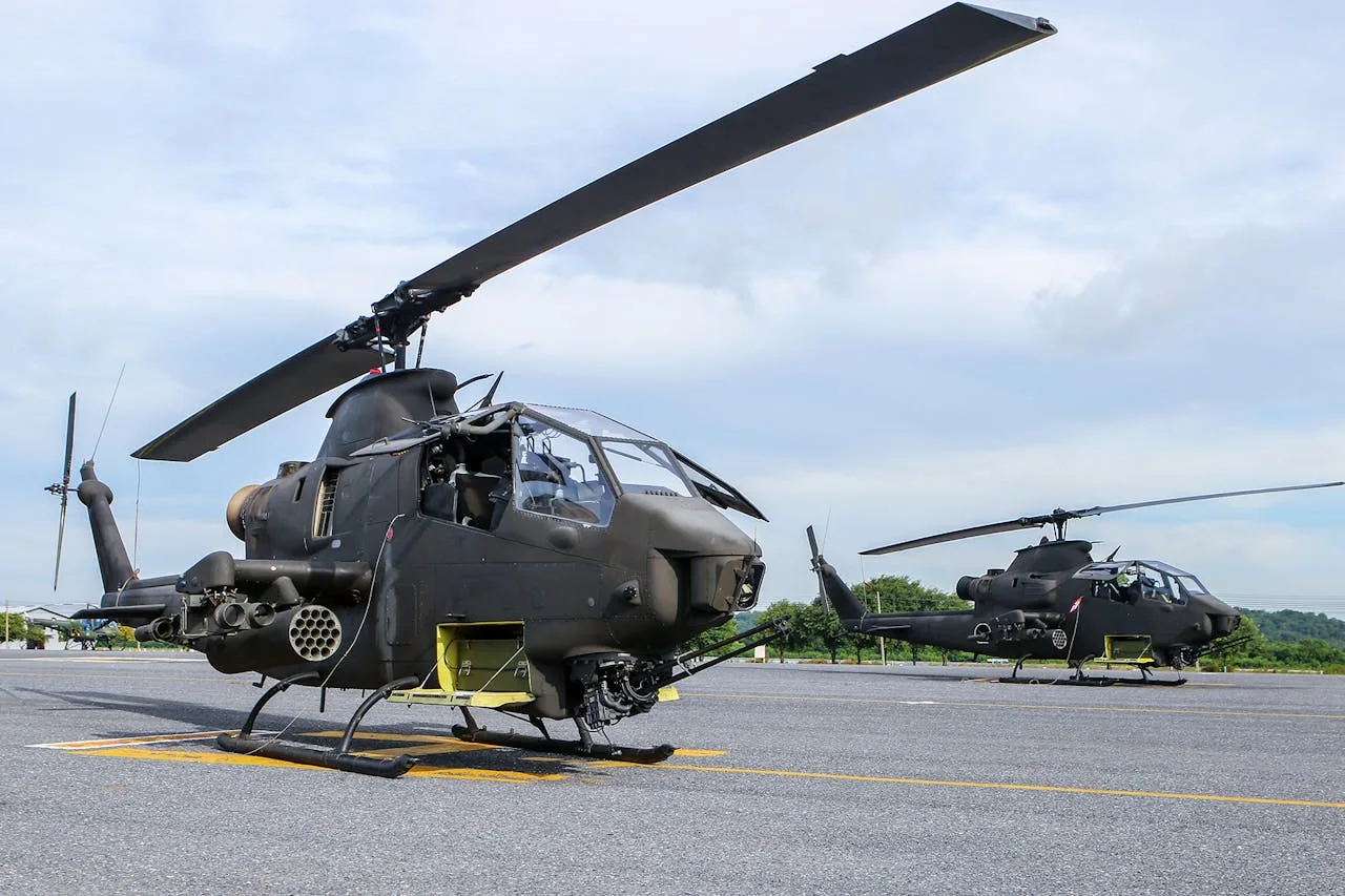 army helicopter in flight over a green landscape