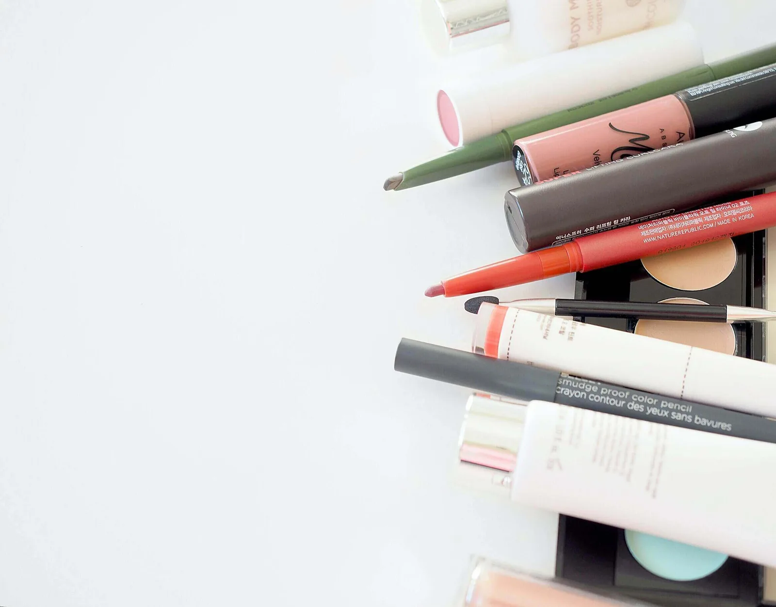 assorted makeup products arranged artistically on a surface