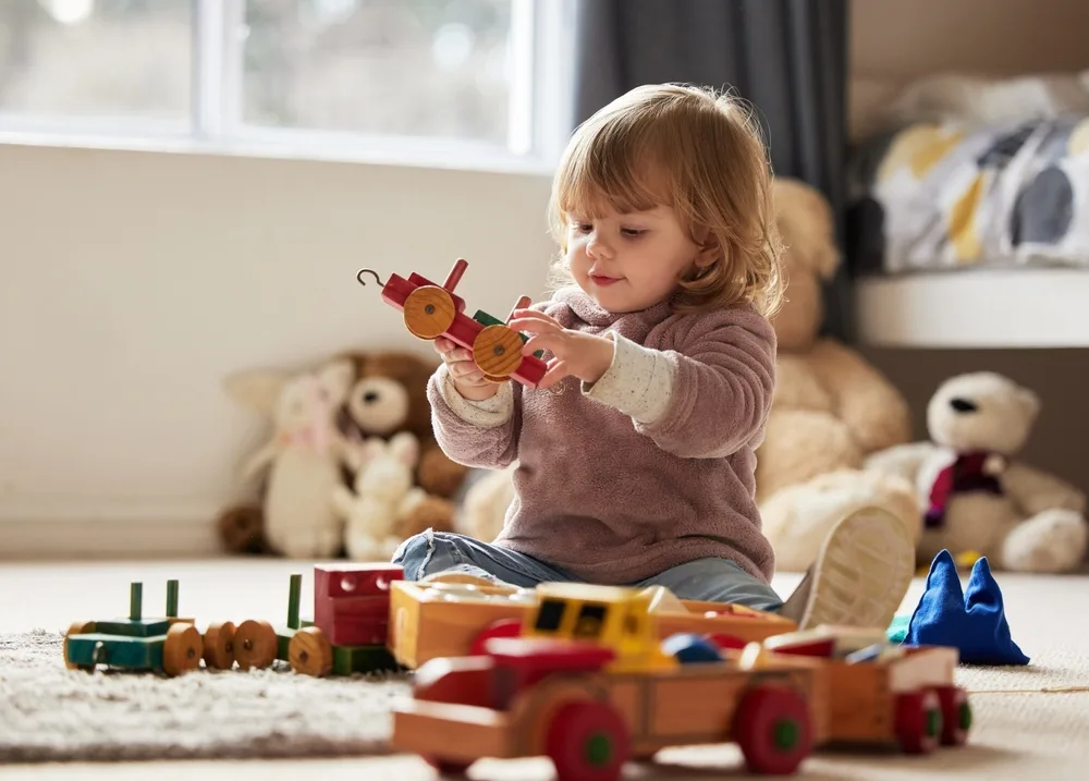 toddler playing with toys at home for development and learning