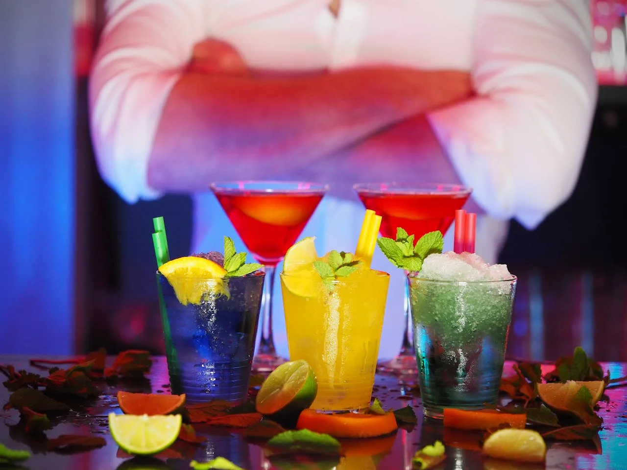 bartender skillfully mixing a colorful cocktail at a bar