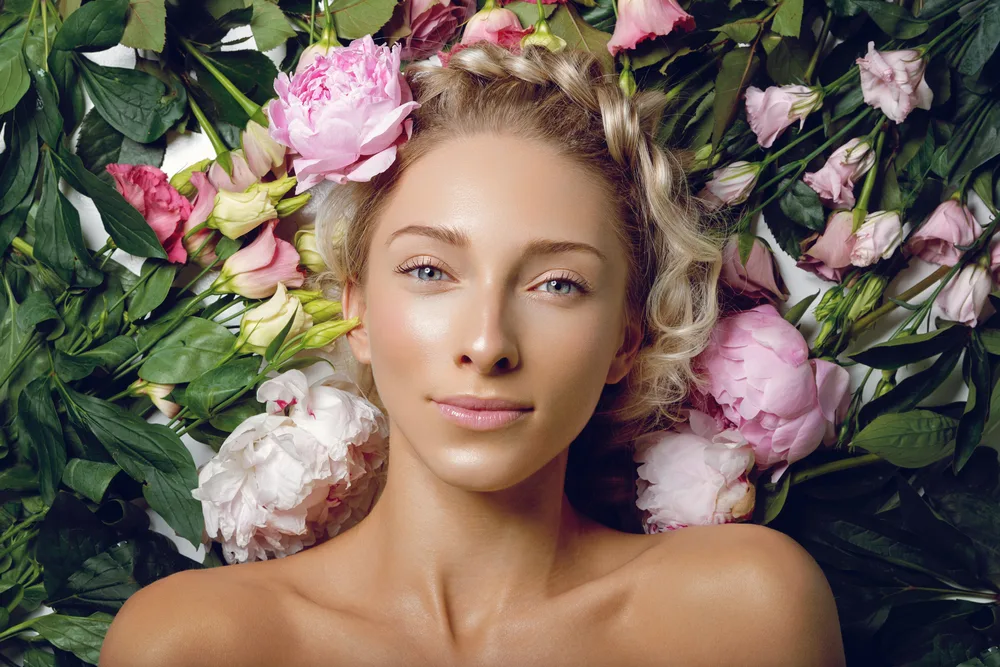 beautiful girl lying in a field of colorful flowers