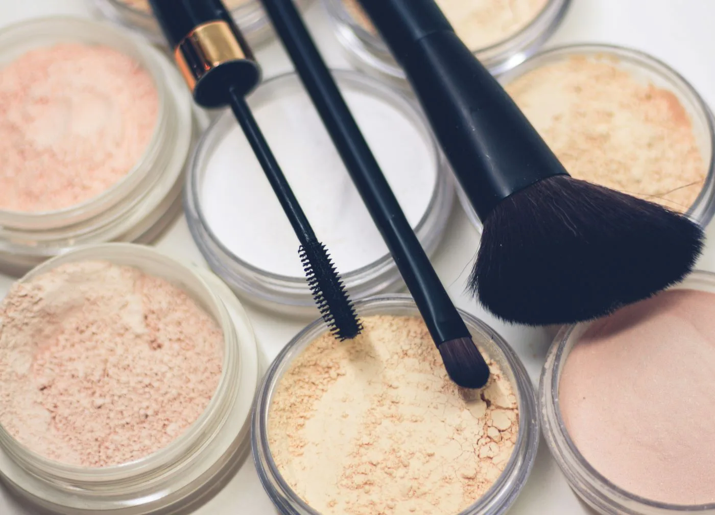 assortment of beauty products on a white surface