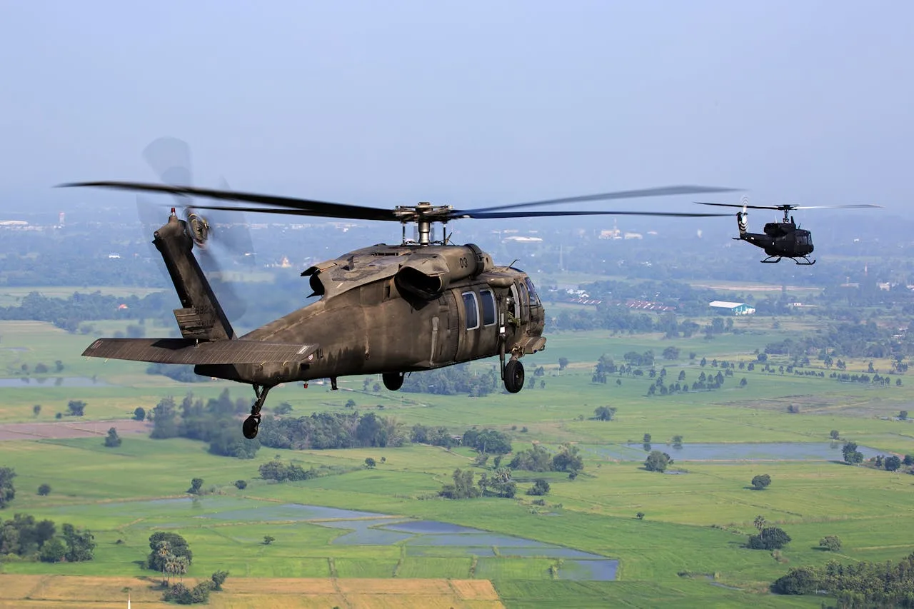 blackhawk helicopter in flight over a landscape