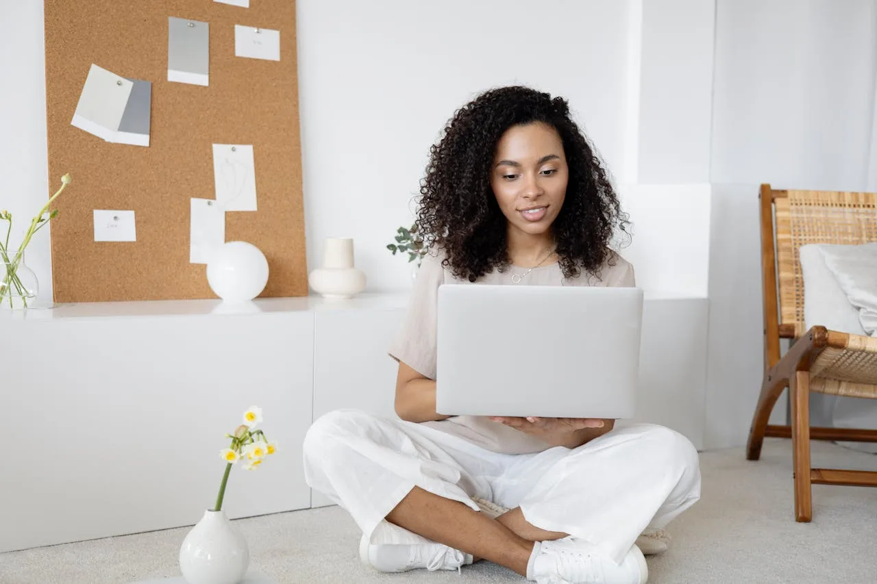 digital marketer using a laptop and tablet for online marketing strategies
