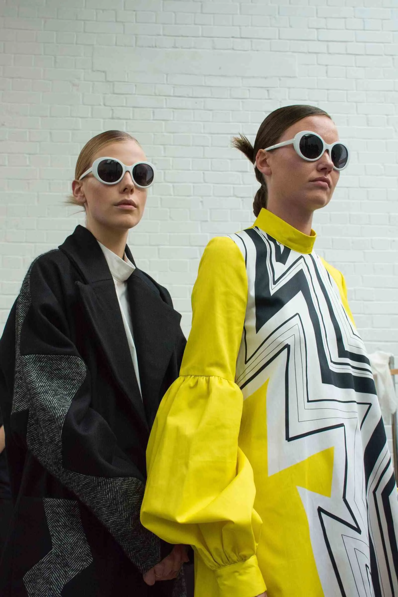 fashion week runway show with models showcasing designer clothing