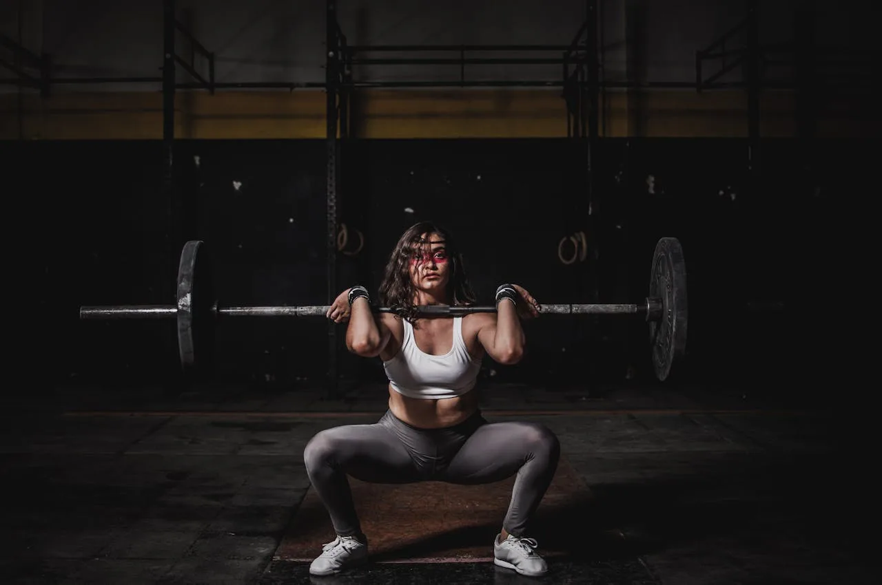 woman performing a fitness squat exercise in a gym