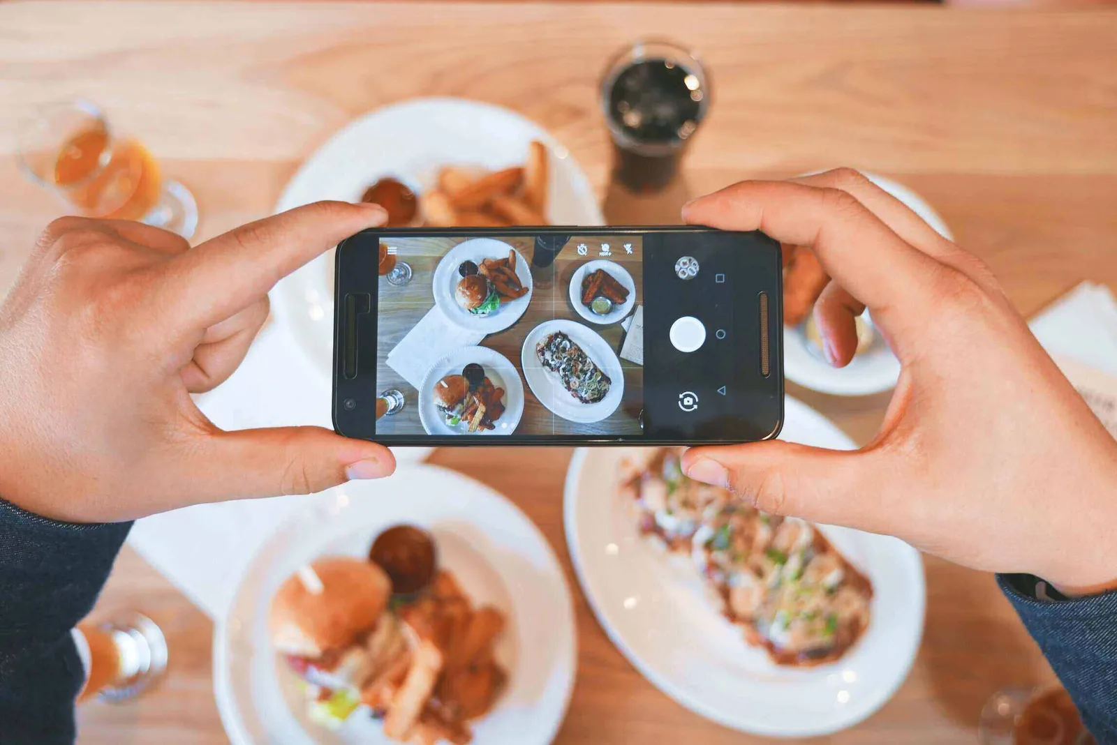 food influencer posing with colorful food dishes at a table