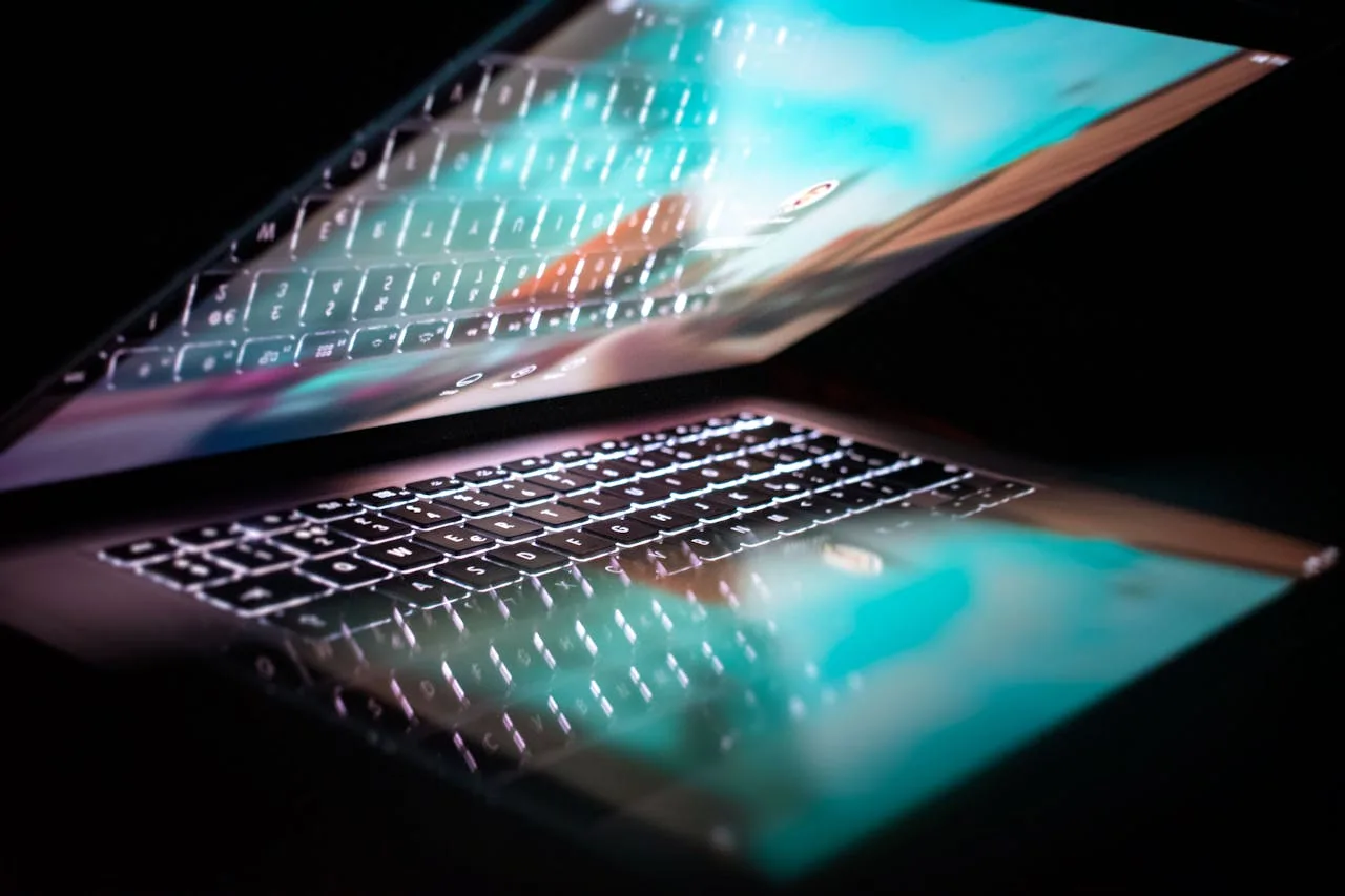 futuristic open laptop with glowing keyboard and screen