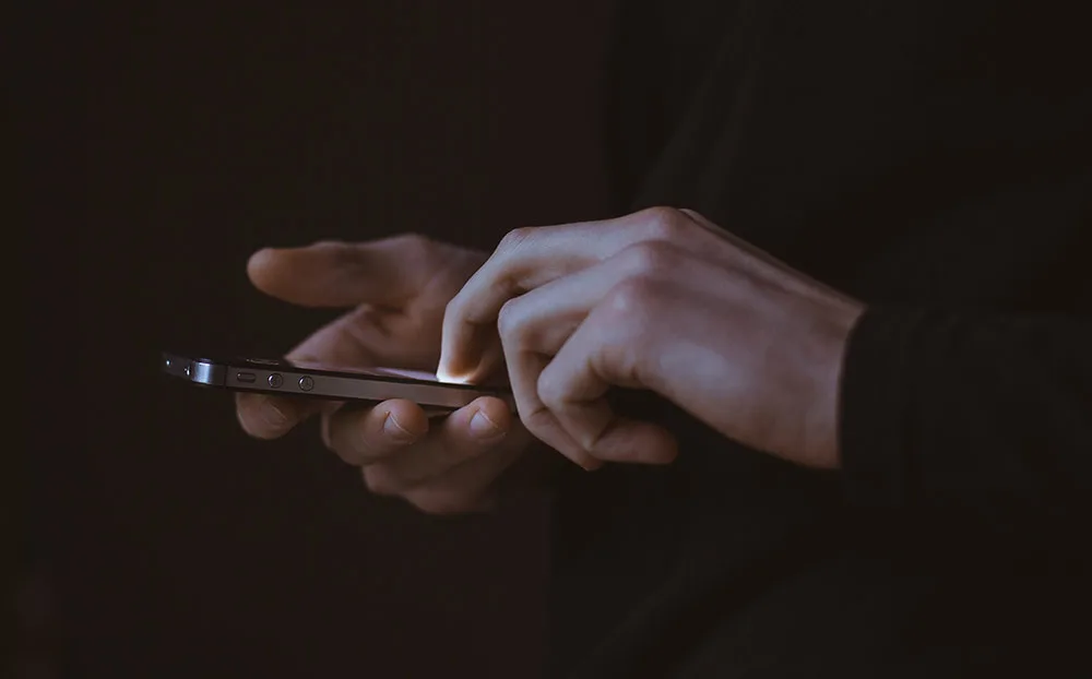 close up of hands holding a smartphone