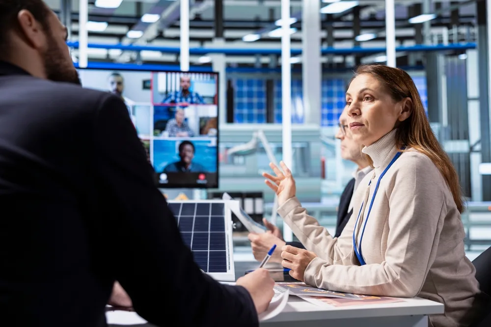 industrial plant shareholders in teleconference meeting reviewing compliance records
