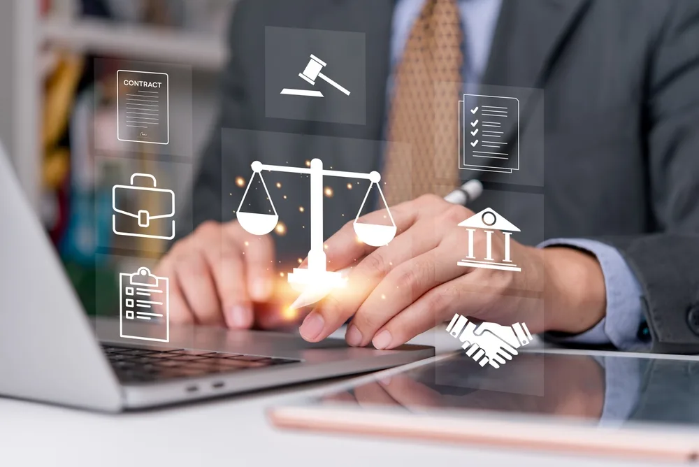lawyer using laptop with digital justice icons symbolizing online legal services