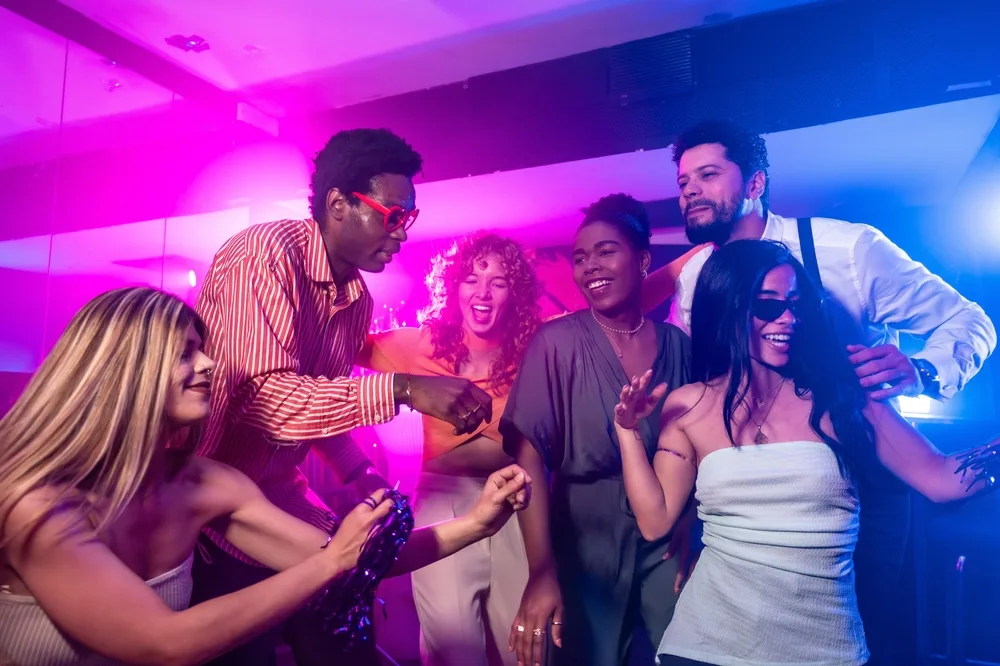 people enjoying a vibrant lifestyle event with music and drinks