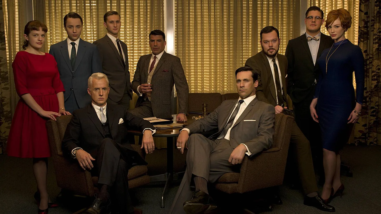 mad men don draper in a suit smoking a cigarette