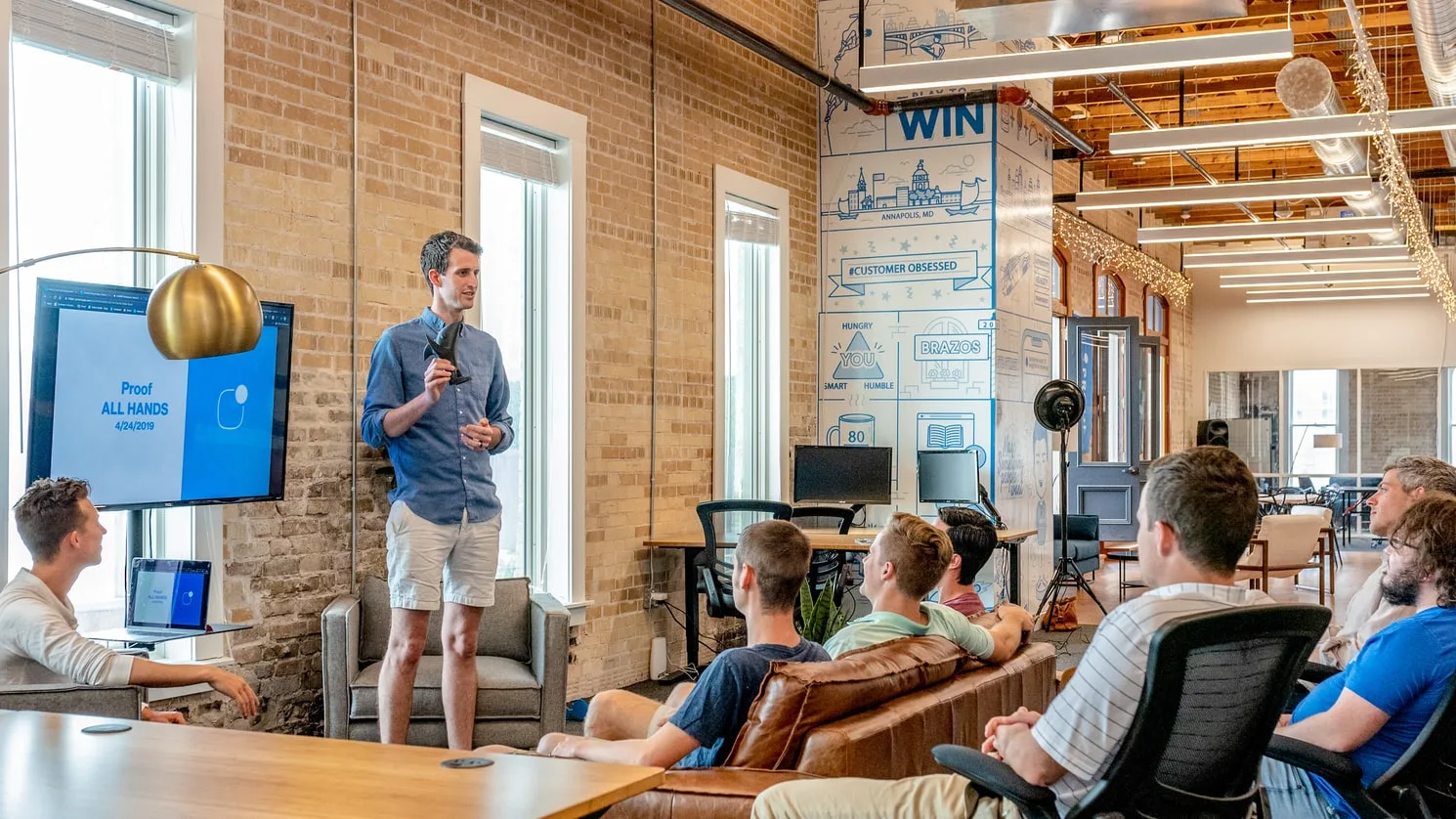 manager overseeing a team in a modern office setting