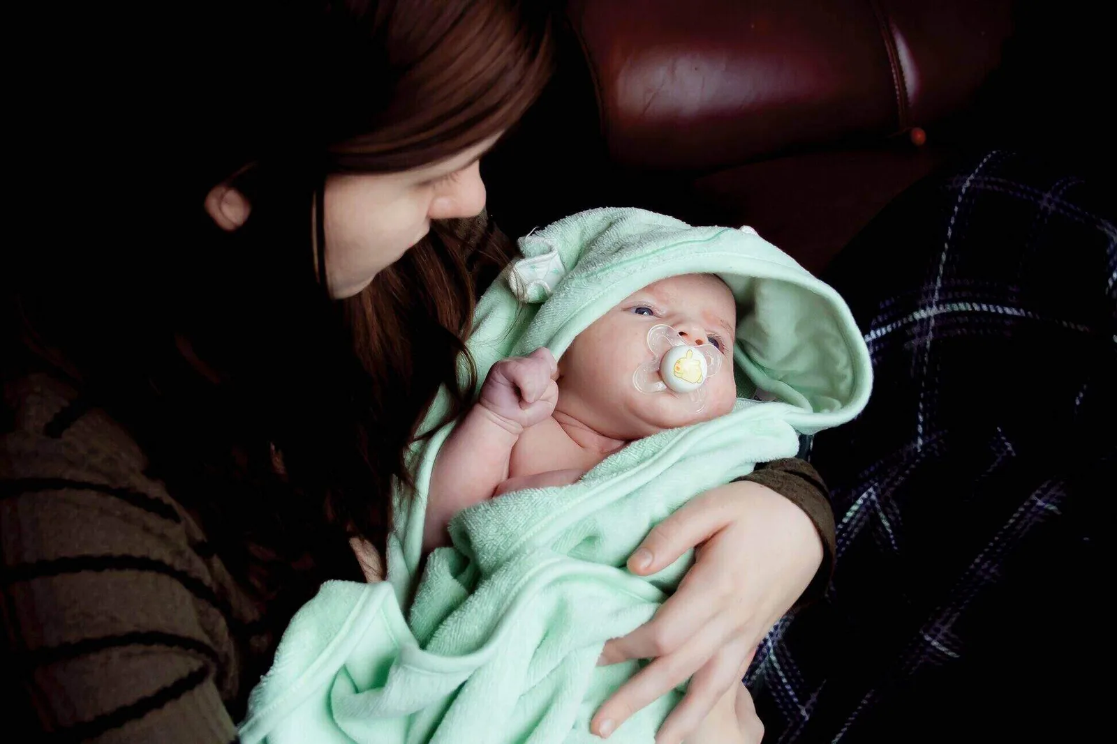 mother lovingly feeding her baby with a bottle