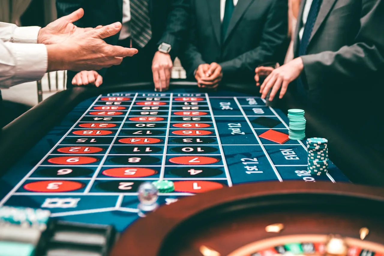 roulette game with chips and cards on a green felt table