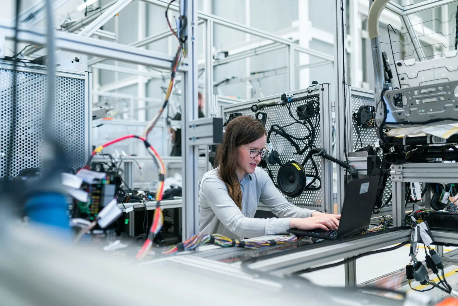 engineer working on a complex circuit board with tools