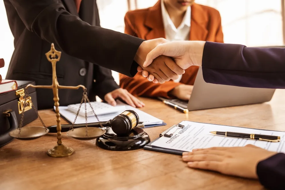 lawyers shaking hands offering legal guidance standing for clients
