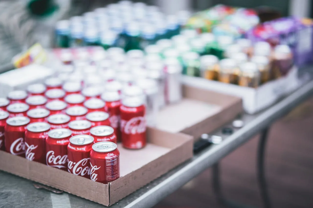 cans of soda in a cpg product display