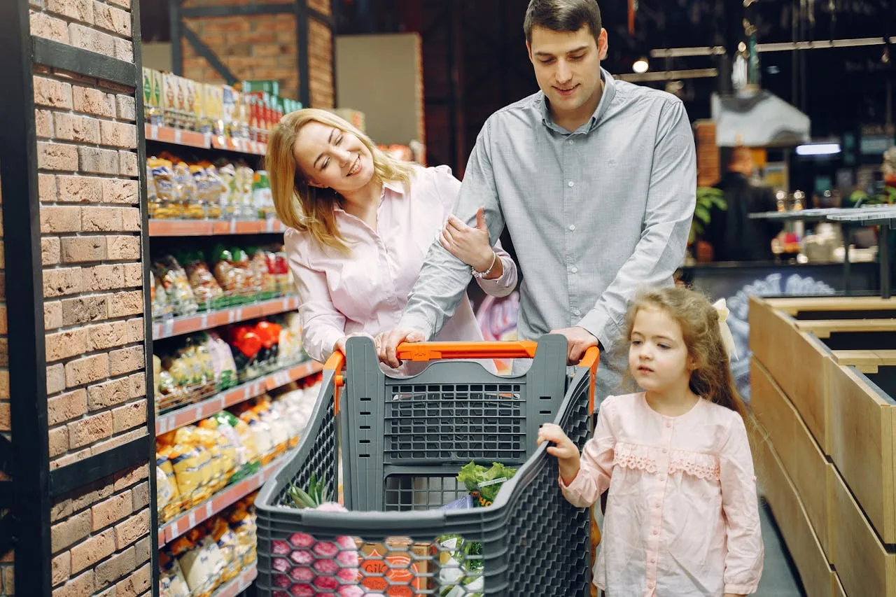 a person pushing a shopping cart through a supermarket aisle