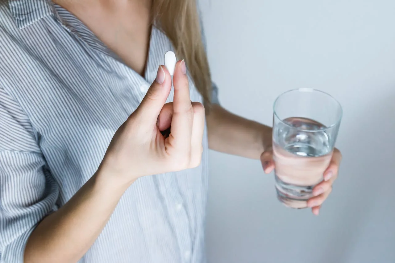 woman drinking supplement water to stay hydrated
