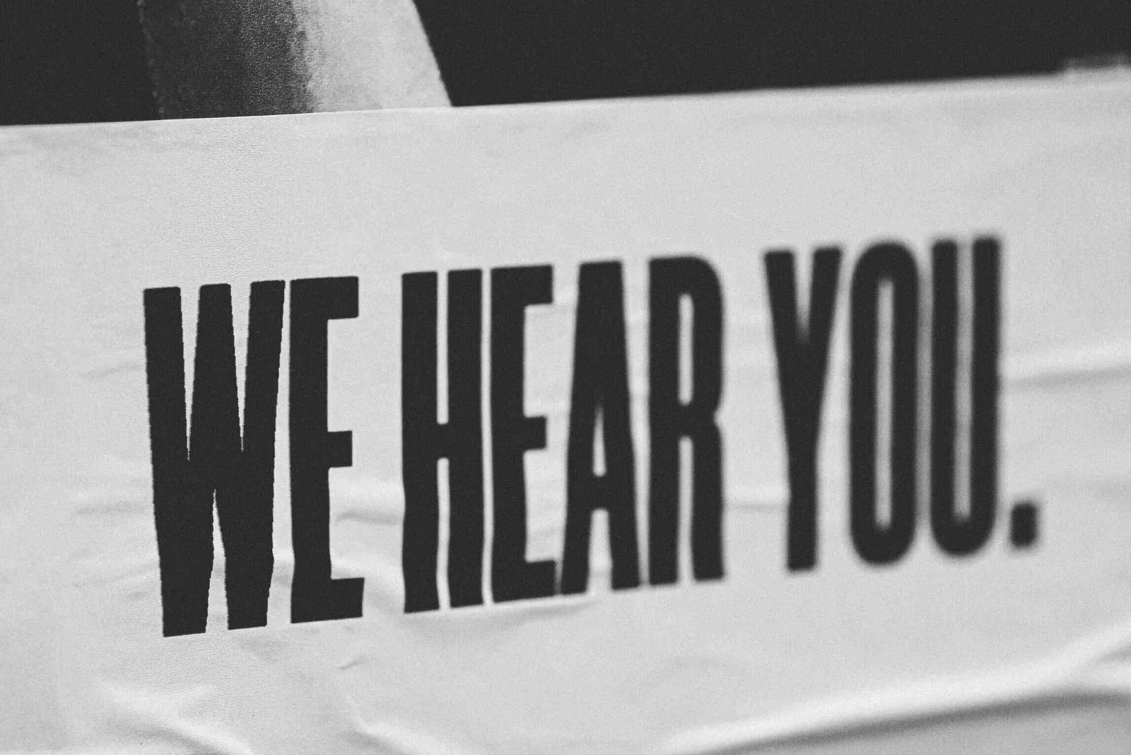 we hear you sign with a white background and black text