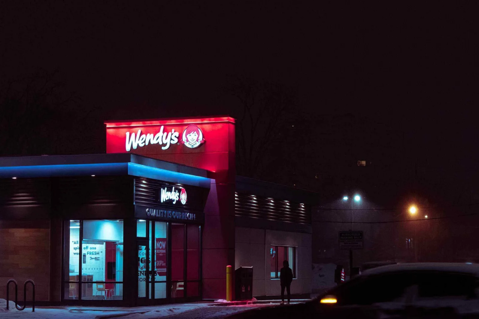 wendys fast food restaurant with a red roof and golden arches sign