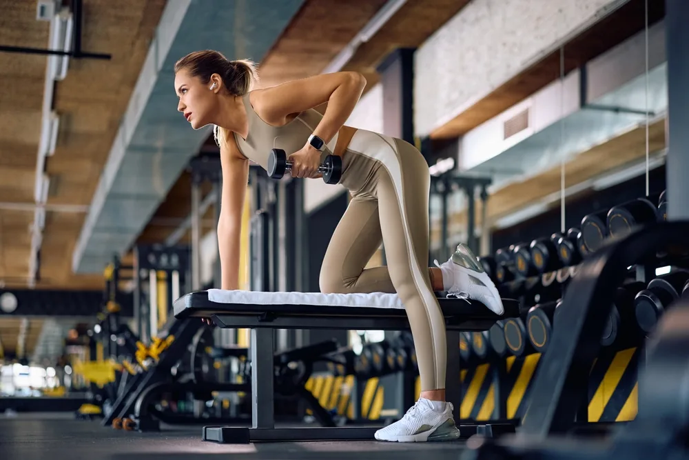 woman exercising in a gym doing a strength training workout
