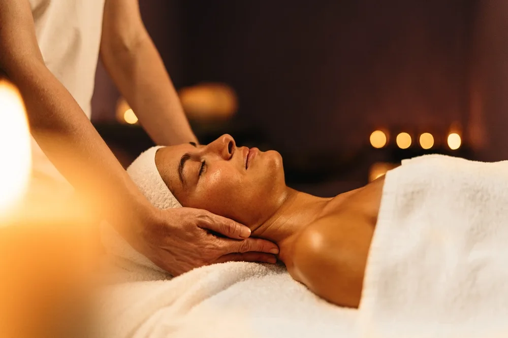 young woman receiving a relaxing massage in a beautiful spa salon